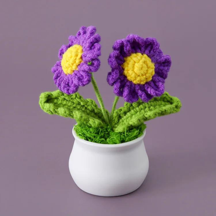 Hand woven crochet purple and yellow flowers in a white pot