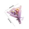 A handmade crochet sunflower mini bouquet wrapped in light purple paper and tied with a lavender ribbon.