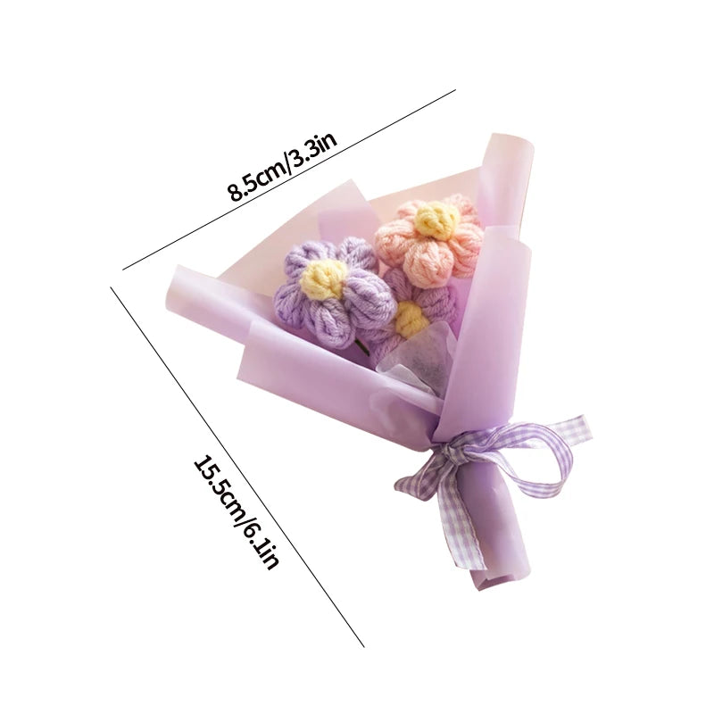 A handmade crochet sunflower mini bouquet wrapped in light purple paper and tied with a lavender ribbon.