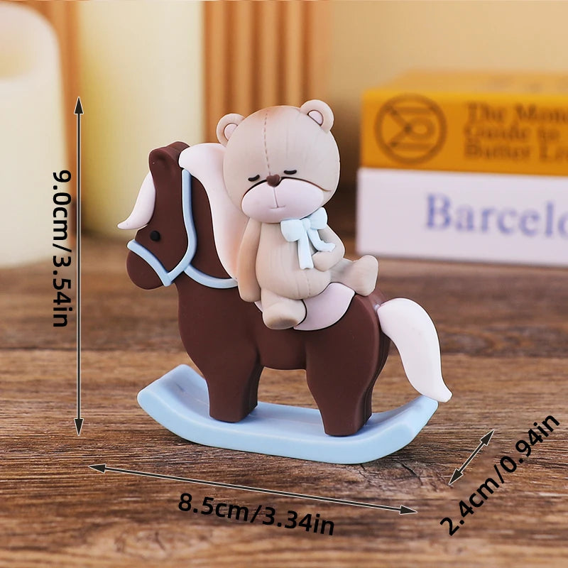 A small wooden baby block topper featuring a bear and a horse design on a light blue base.