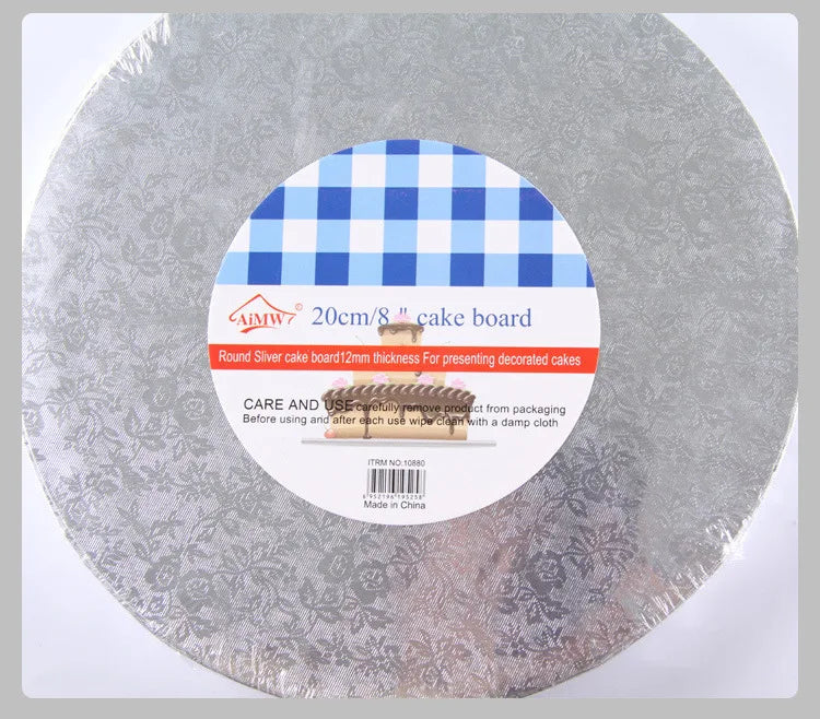 Round silver cake board with a blue checkered pattern and a wooden presentation stand.