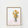 Botanical Philodendron canvas wall art featuring yellow flowers in a glass vase on a pink plaid surface.