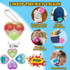 A collection of mini sensory fidget keychains in various colors and shapes, including heart-shaped and oval designs.