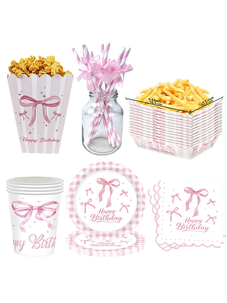 A set of pink bow themed birthday party supplies including popcorn, french fries, and paper cups.