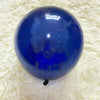 A glossy blue latex balloon resting on a white, fluffy surface.