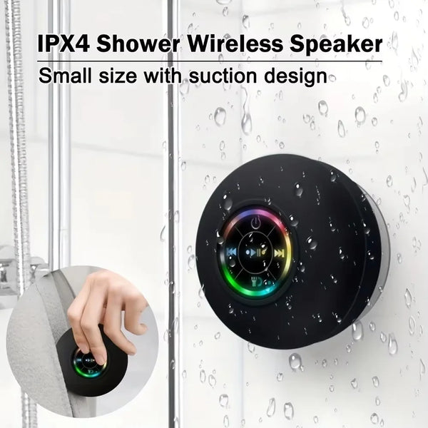 A black waterproof speaker with a suction design is shown being installed on a glass shower door.