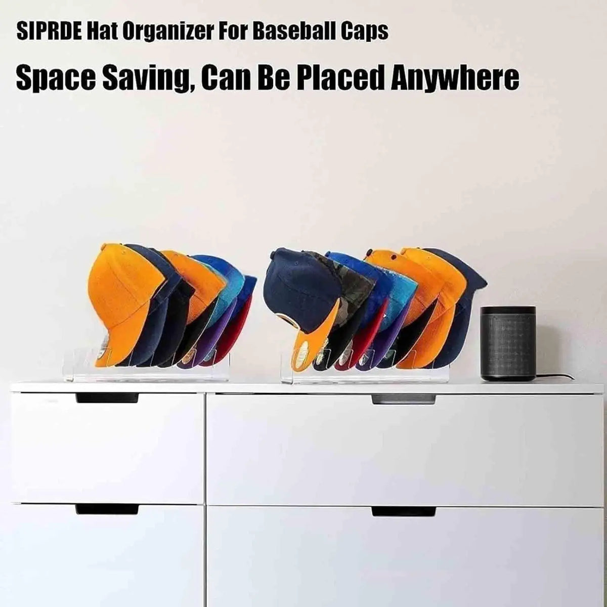 A stack of colorful baseball caps is displayed on a clear acrylic organizer rack inside a white drawer.