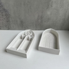 White silicone molds shaped like church windows for resin and plaster crafting