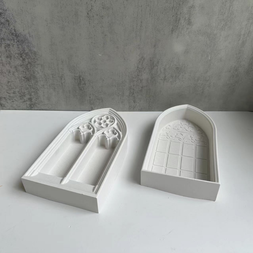White silicone molds shaped like church windows for resin and plaster crafting