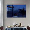 A canvas wall art poster featuring a silhouette of a man looking out over the ocean with the text The world is yours.