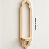 A vertical wooden wall shelf shaped like an arch with a decorative top and a small shelf underneath.