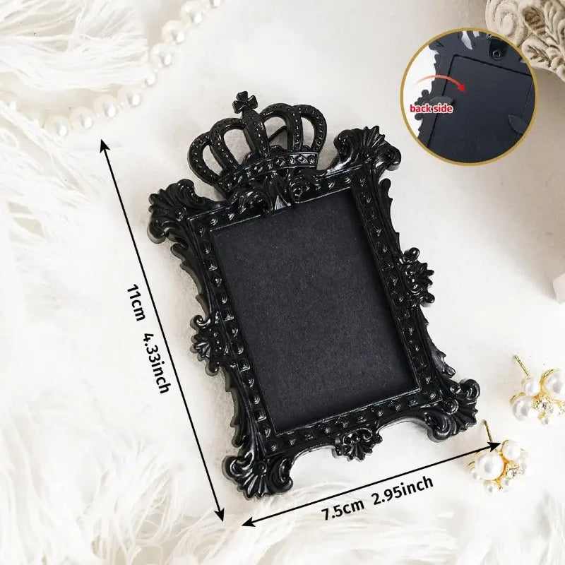 Black ornate vintage resin mini picture frame displayed on white fluffy fabric