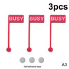 A set of three red busy desk signs with long sticks and self-adhesive tape for focused work