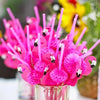 A bouquet of bright pink 3D flamingo and pineapple paper straws in a glass container.