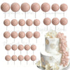 A set of pink foam cake toppers on sticks, including round and petal shapes.