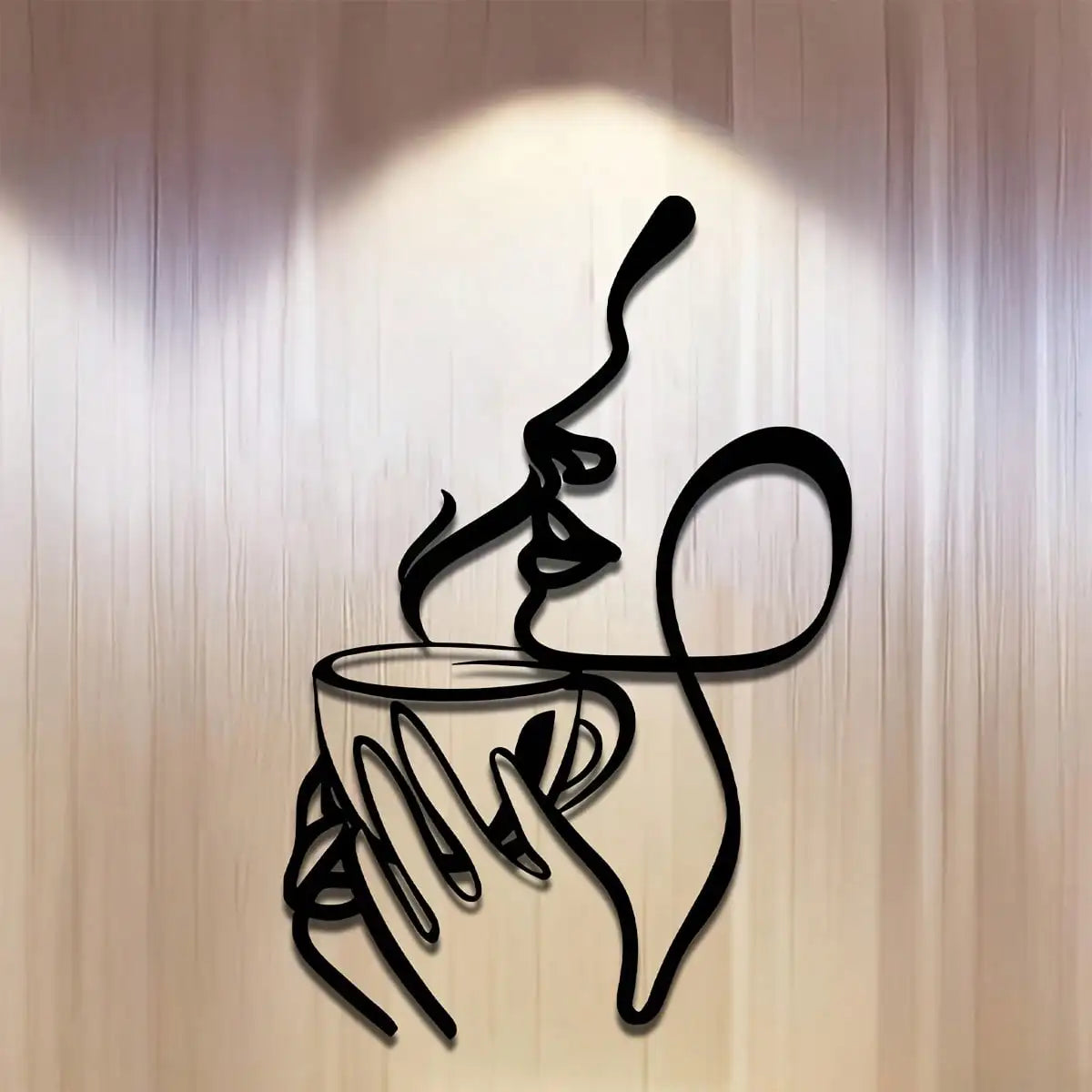 A black line art sculpture of a hand holding a cup with steam rising, mounted on a light-colored wall.