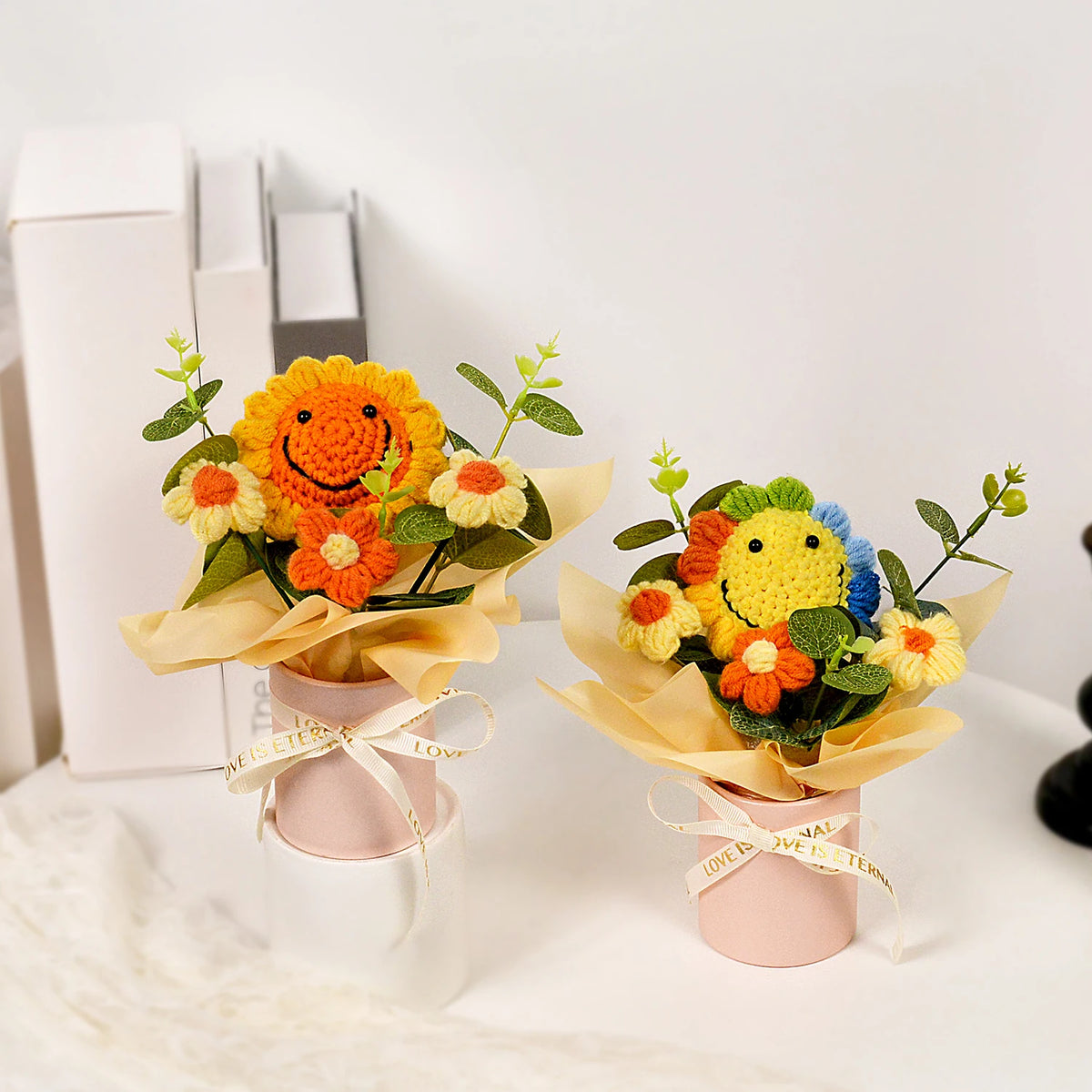 Handmade crochet sunflower bouquet with green leaves presented in a pink gift box