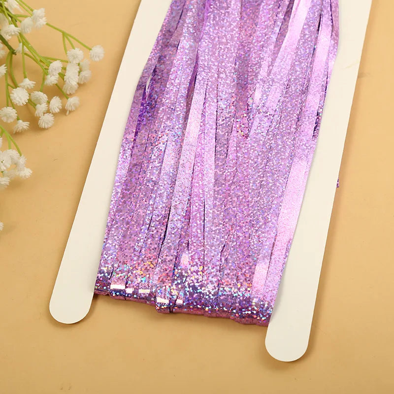 Purple metallic tinsel foil fringe curtain backdrop for parties displayed on a white card.