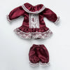 A vintage lace pajama set for a doll featuring a maroon top and matching bottoms with white lace trim.