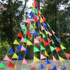 A tall display of colorful pennant banner flags arranged in a pyramid shape.