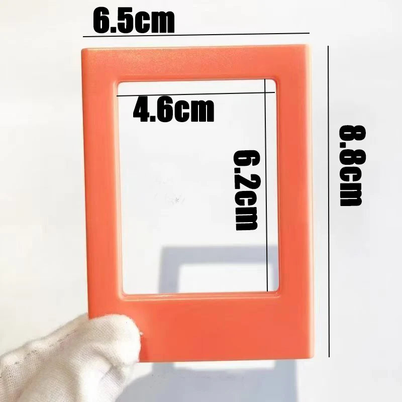 An orange magnetic photo frame with dimensions 6.5cm by 8.8cm and an inner area of 4.6cm by 6.2cm.