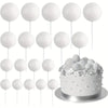 A set of twenty white spherical cake toppers on sticks arranged above a silver cake plate.