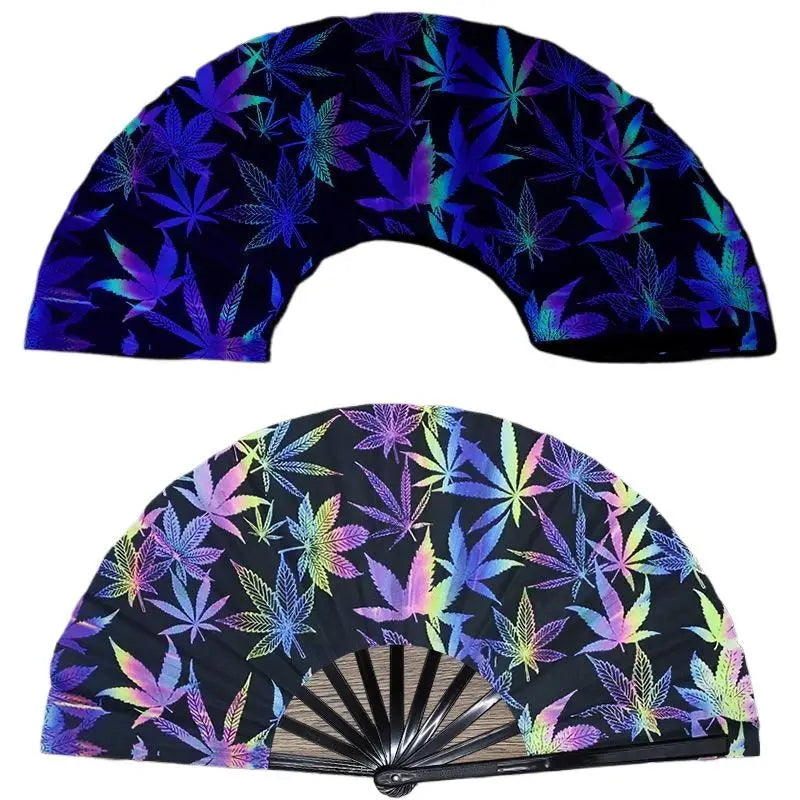 A dark blue folding fan with a vibrant purple and green UV fluorescent cannabis leaf pattern.