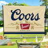 A beige flag banner featuring the word Coors in dark blue script above a silhouette of mountains and the text Since 1873.