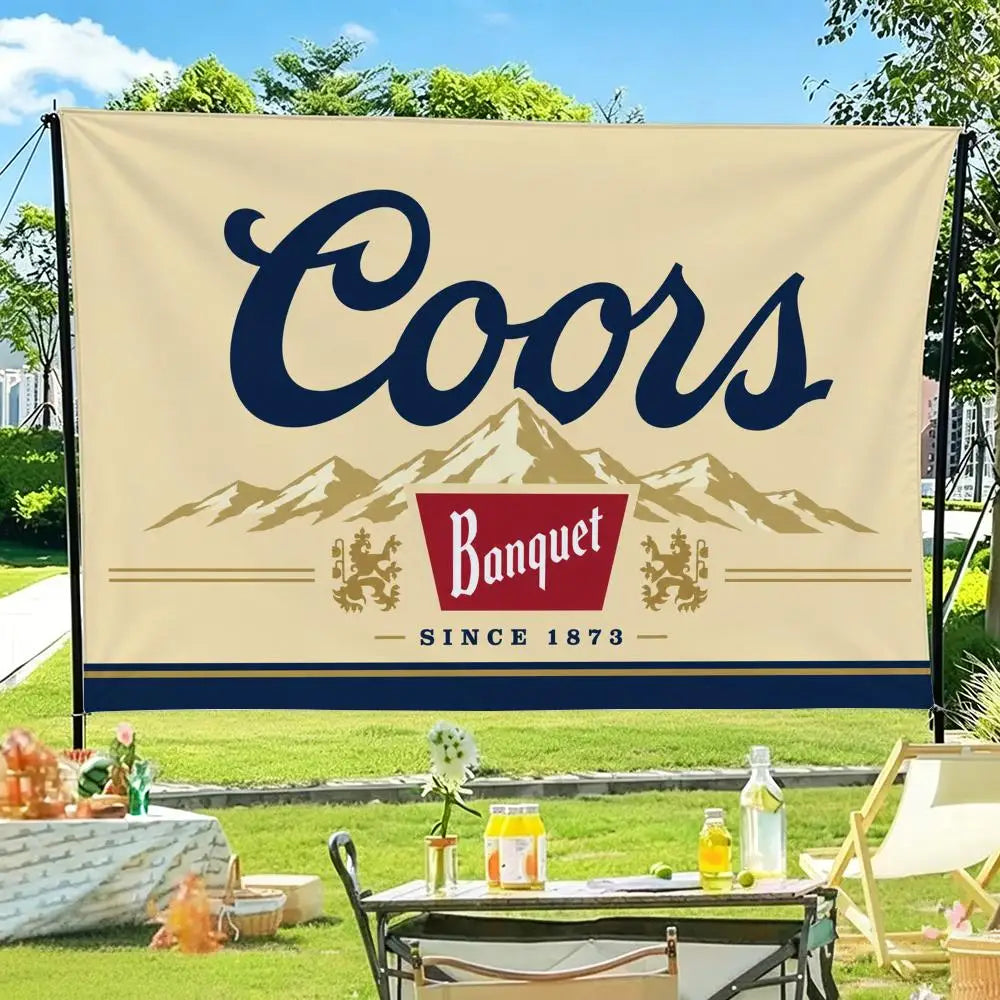 A beige flag banner featuring the word Coors in dark blue script above a silhouette of mountains and the text Since 1873.