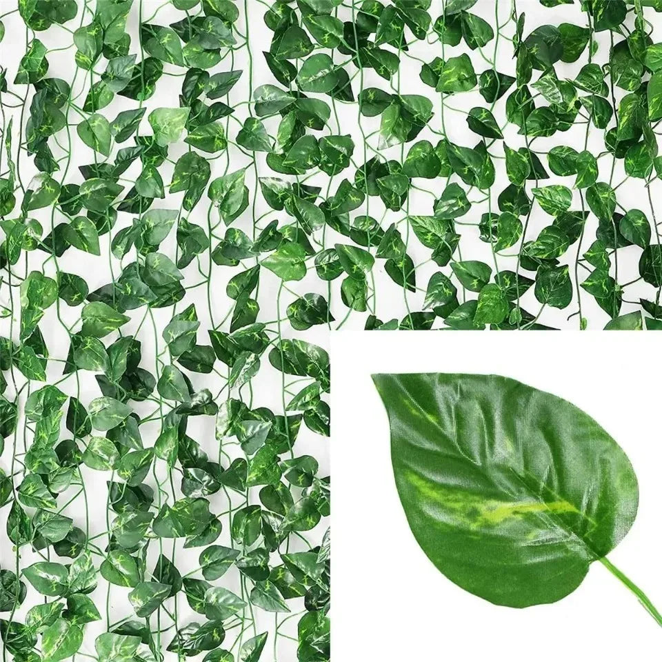 Green artificial ivy vine garland covering a white background with a single leaf detail