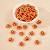 A white bowl filled with 20 small orange resin pumpkin charms for fall decor, with several loose pumpkins scattered nearby.