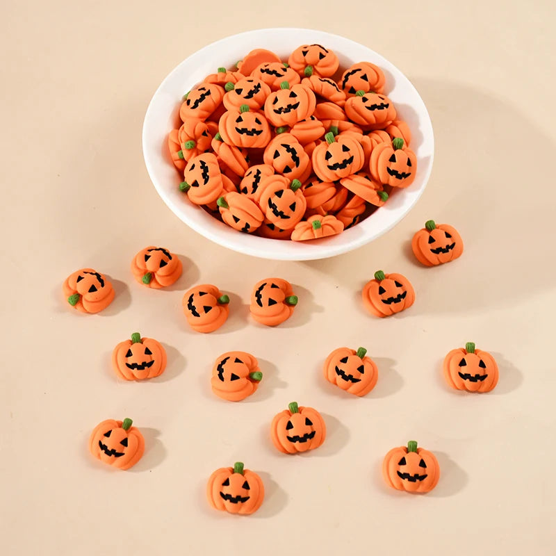 A white bowl filled with 20 small orange resin pumpkin charms for fall decor, with several loose pumpkins scattered nearby.
