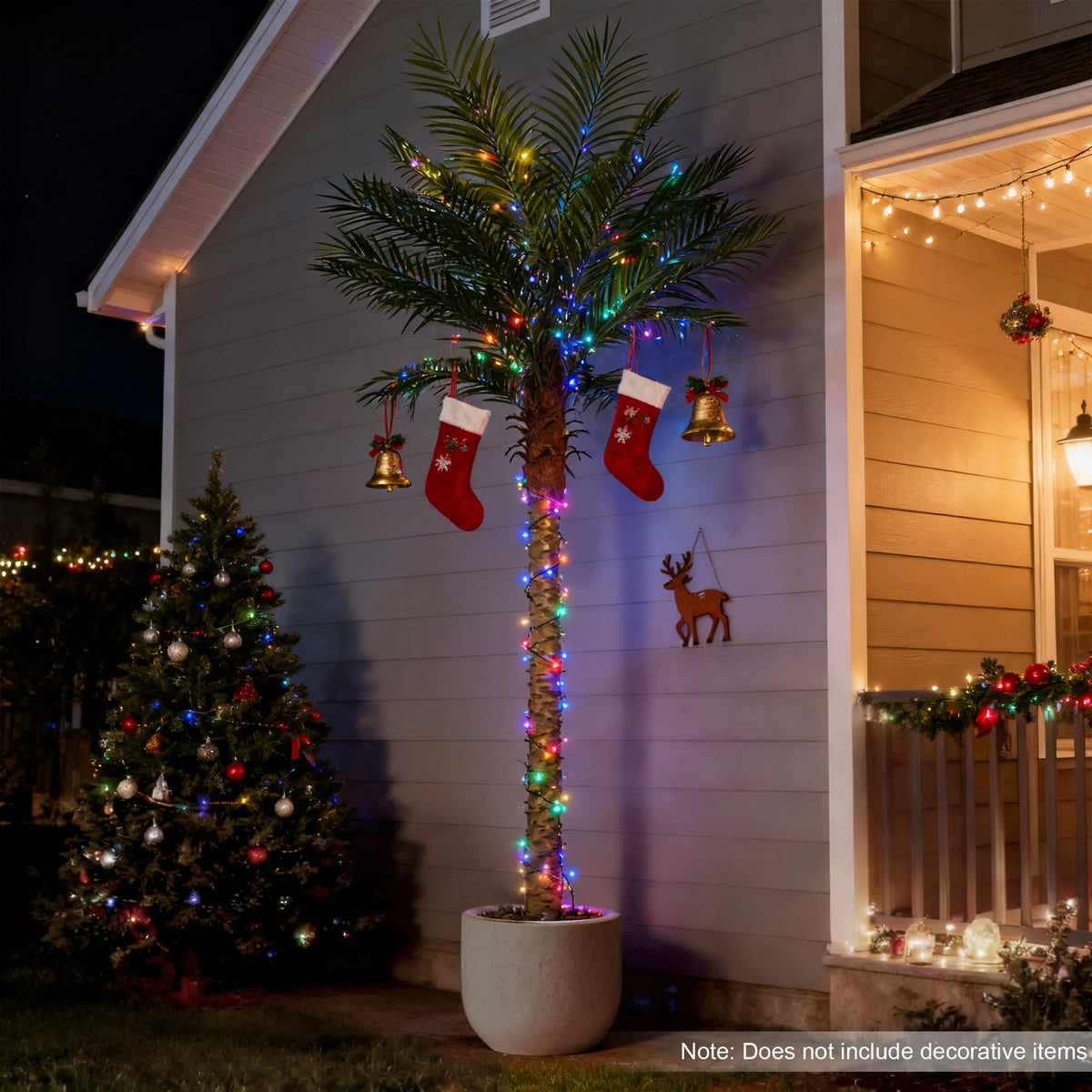 An artificial golden palm tree decorated with string lights stands against a light gray wall.