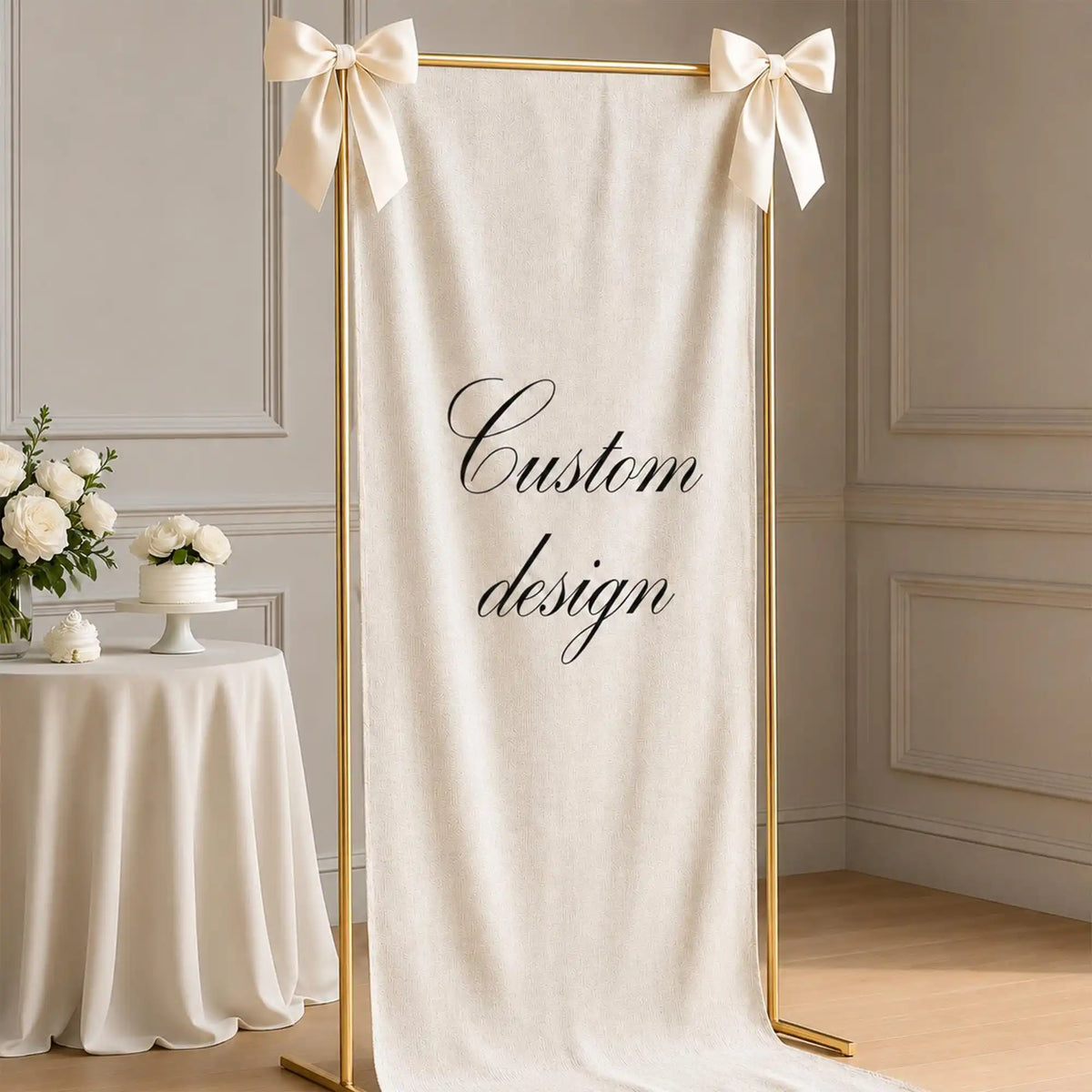 A cream linen banner with gold trim and bow ties displayed against a light wall.