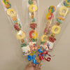 Clear cellophane gift bags filled with colorful candies, cookies, and party favors tied together.