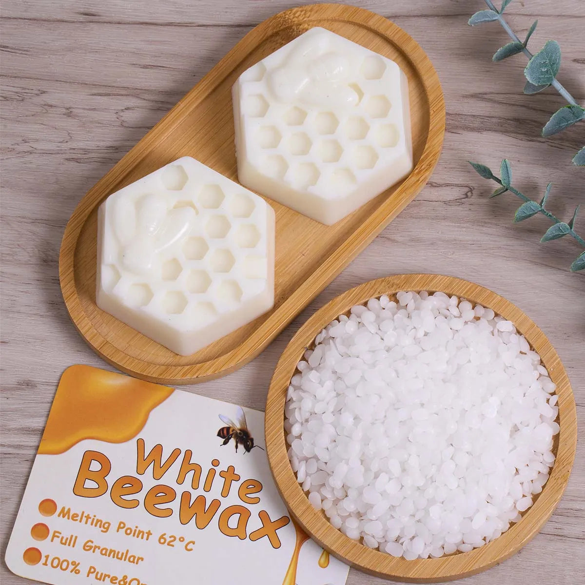 White beeswax blocks and granular white wax are displayed on a wooden tray.