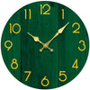 A round wooden wall clock with a dark green background and gold-colored hands and numerals.