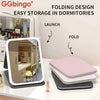 Folding design vanity mirror for easy storage in dormitories shown with a pink folding cover.