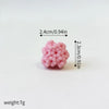 A set of three pink, spherical ocean animal cake toppers including a whale, octopus, and turtle.