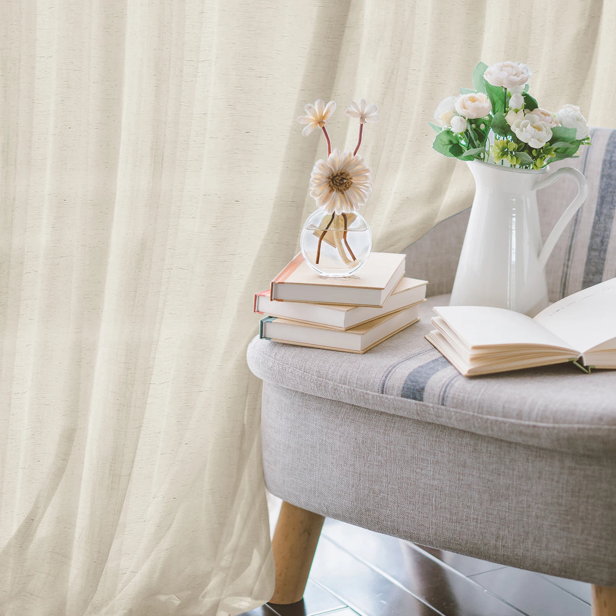 Natural linen sheer curtains with a rod pocket hanging in a bright living room setting.