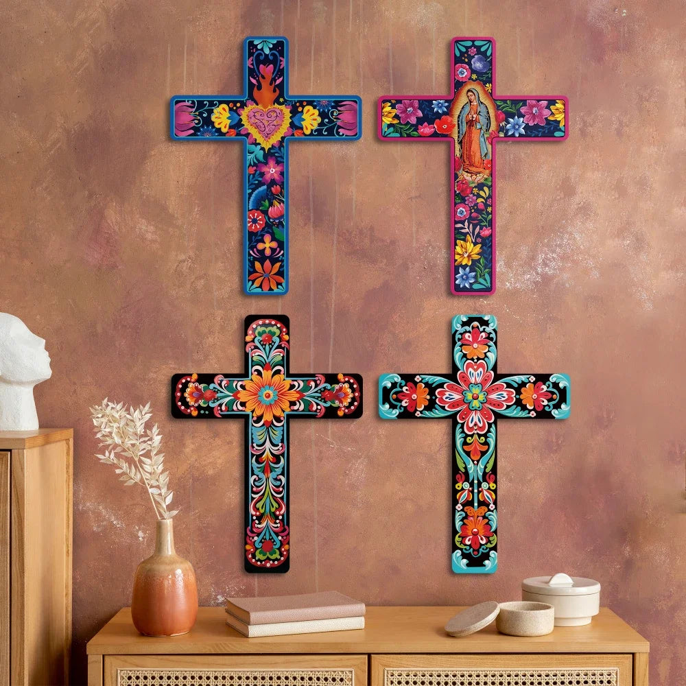 A set of four wooden crosses with colorful floral designs displayed on a brown wall.