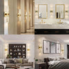 Modern bubble crystal LED wall sconces illuminating a luxurious bathroom vanity area.