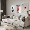 A modern living room features a light sofa and decorative wall art with red and blue designs.