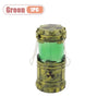 A small, cylindrical lantern-style device with a brass finish and an eerie green glow.