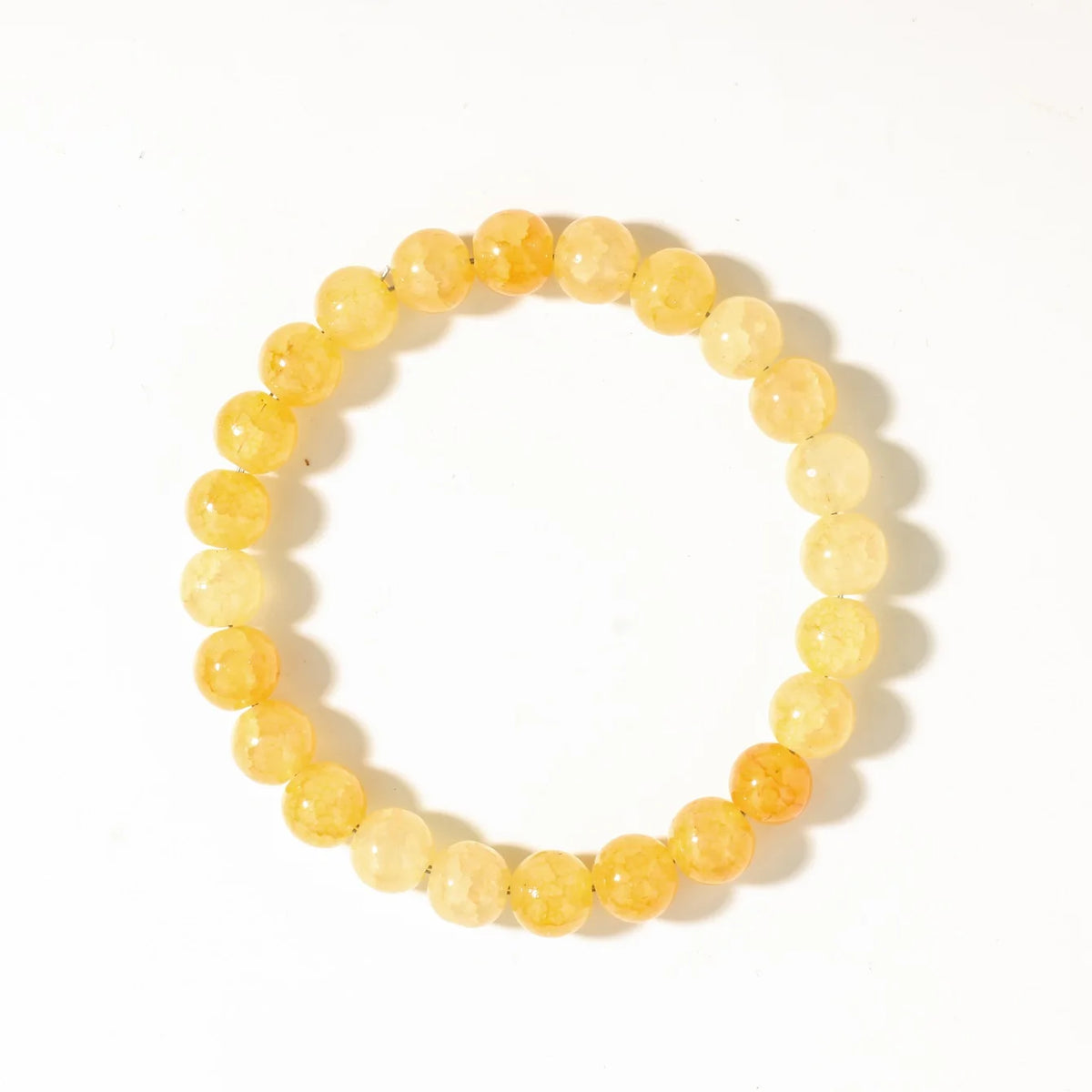 A bracelet made of small, round, yellow-orange citrine crystals.