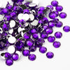 A pile of round flatback resin rhinestones in various shades of purple and silver.