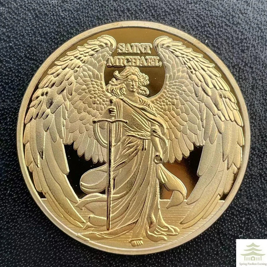 A gold souvenir coin featuring the figure of Saint Michael with wings and a spear.