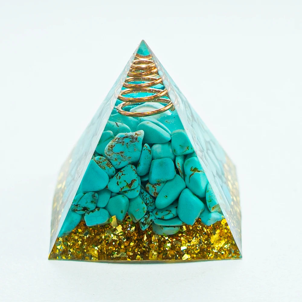 A pyramid-shaped crystal display featuring turquoise stones and gold flakes.