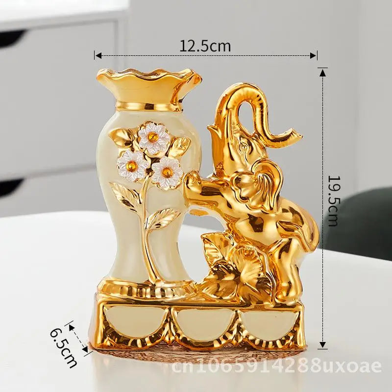A pair of elegant gold and white ceramic vases featuring a swan and a mythical creature design.