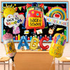 An arrangement of colorful back to school decorations including a backpack, rainbow, and letter balloons.
